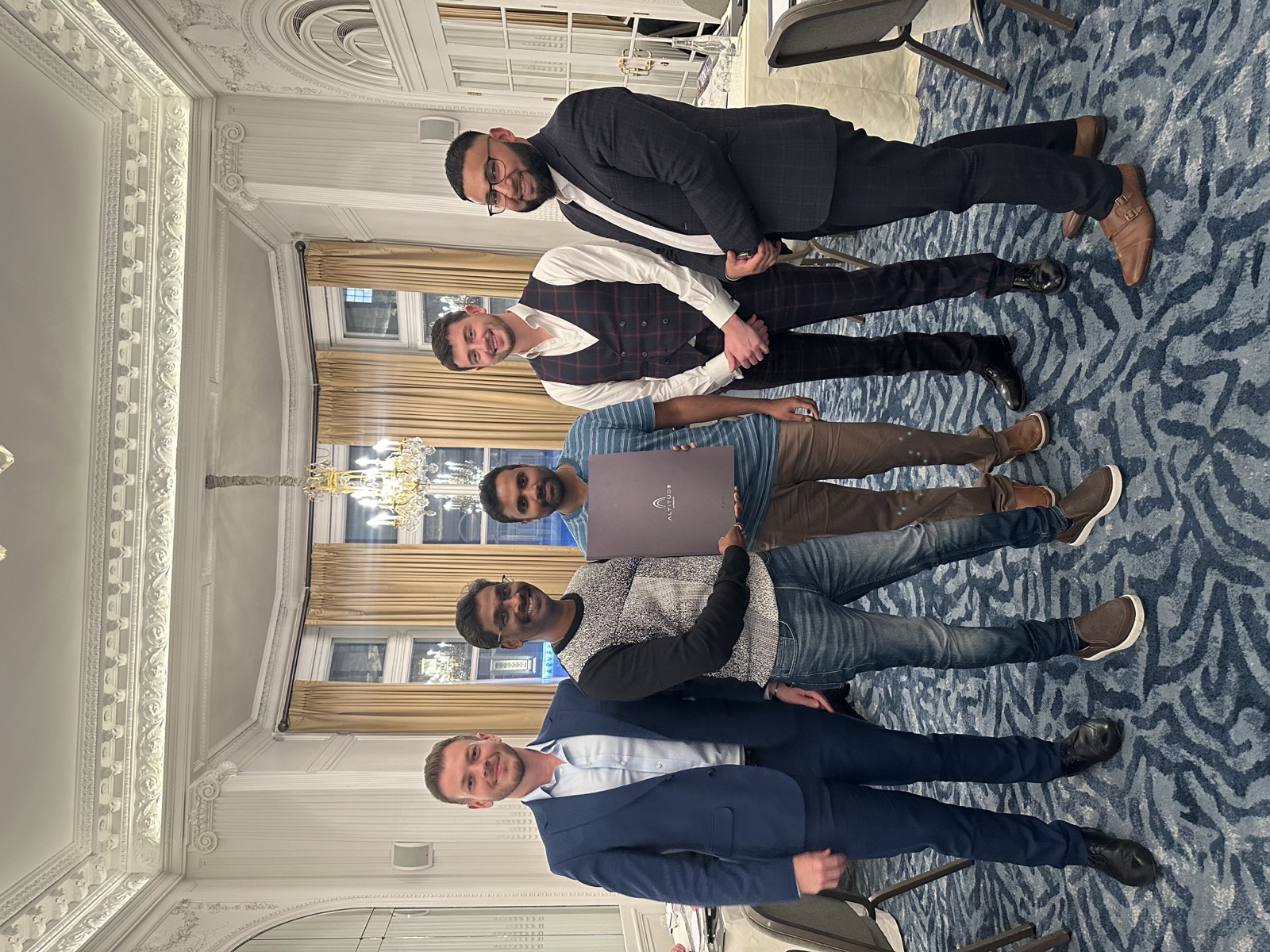 Tazz Miah with clients receiving their property documents